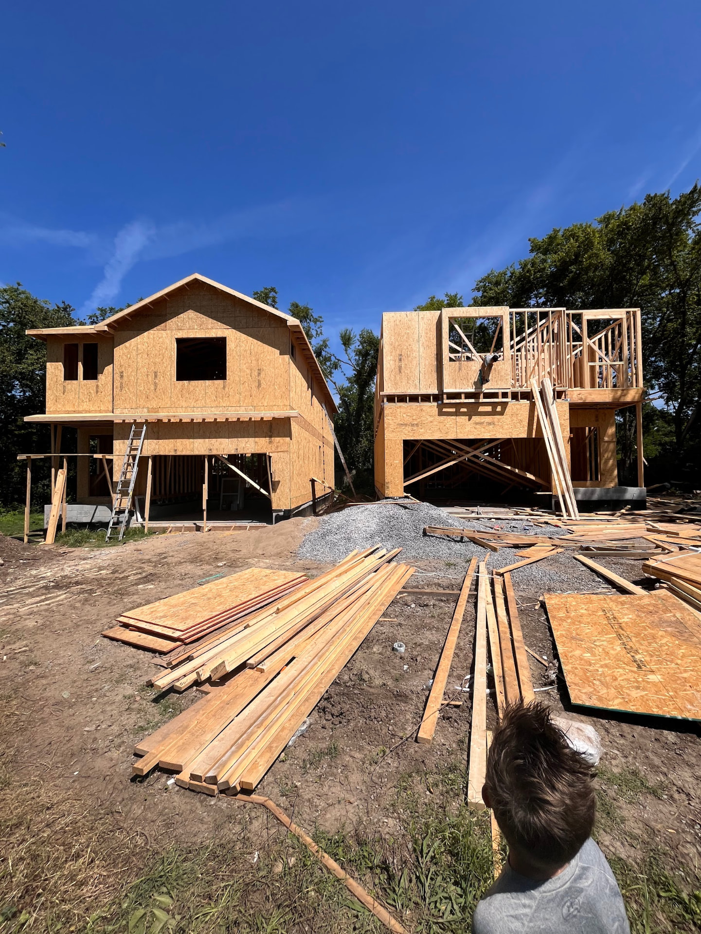 Two framed units at 616 W Green Lane with lumber staged on site